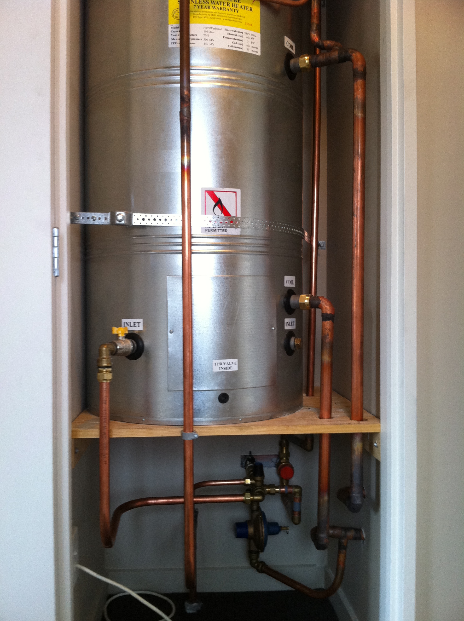 Indoor stainless steel cylinder with intricate copper pipework and tempering valve
